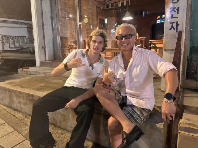 Luca Nowakowski 26 an Italian model poses with a friend he affectionately calls his uncle in Haebangchon Yongsan District central Seoul on Aug 20 2026 AJP Ryu Yuna