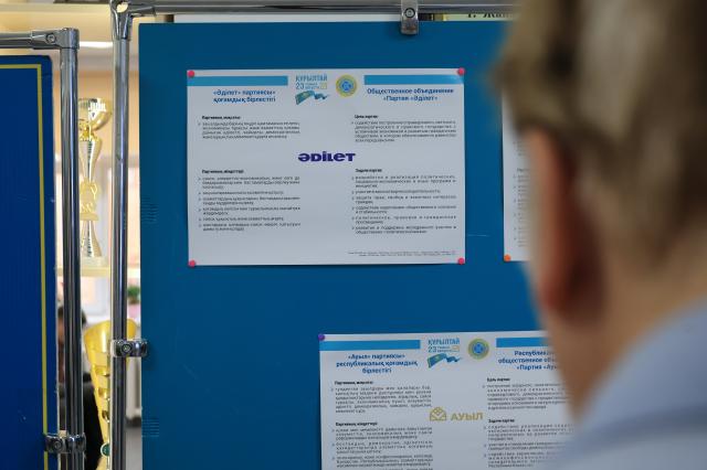 A citizen looks at a board explaining the policies of Kazakhstans political parties at a polling station in Astana Kazakhstan August 23 2026 AJP Han Jun-gu