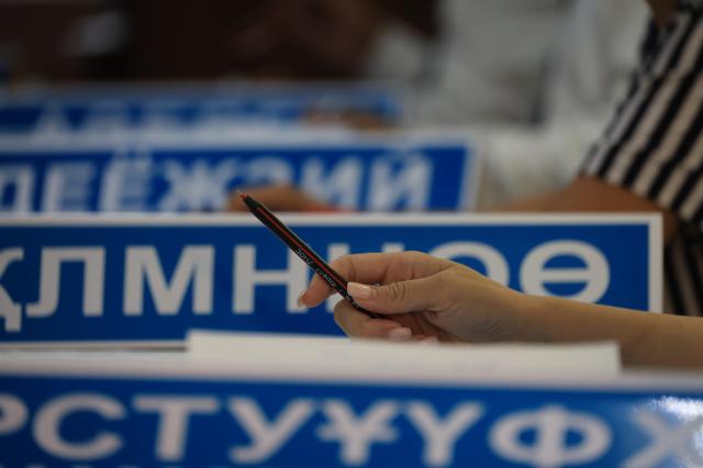 Election officials wait for voters at a polling station in Astana Kazakhstan August 23 2026 AJP Han Jun-gu