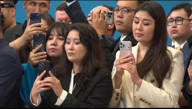 Photo showcasing various reporters from Kazakhstan news media on the photo wall of the president casting vote through the country Phoro provided by the astana government 