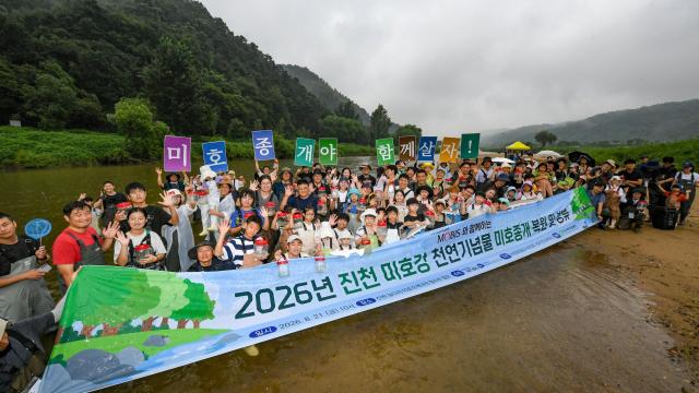 현대모비스 임직원과 가족들이 충북 진천군 미호강 일대에서 천연기념물 미호종개 치어를 방류하고 있는 모습사진현대모비스