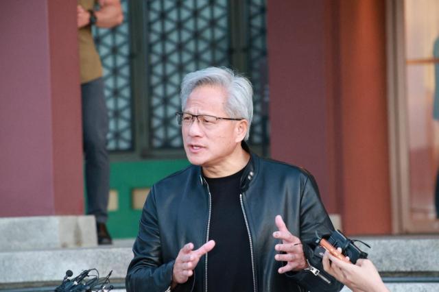 Jensen Huang talks to reporters during his visit in South Korea Pool photo