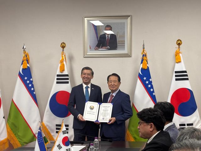 Alisher Abdusalomov Uzbekistan’s ambassador to South Korea poses with a participant holding a certificate of appreciation at the Embassy of Uzbekistan in Seoul on Aug 26 2026 AJP Ryu Yuna