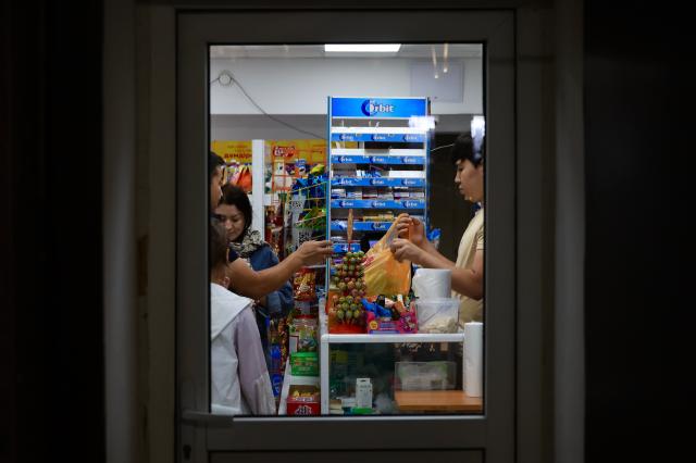 Customers make purchases at a small convenience store in Astana Kazakhstan AJP Han Jun-gu