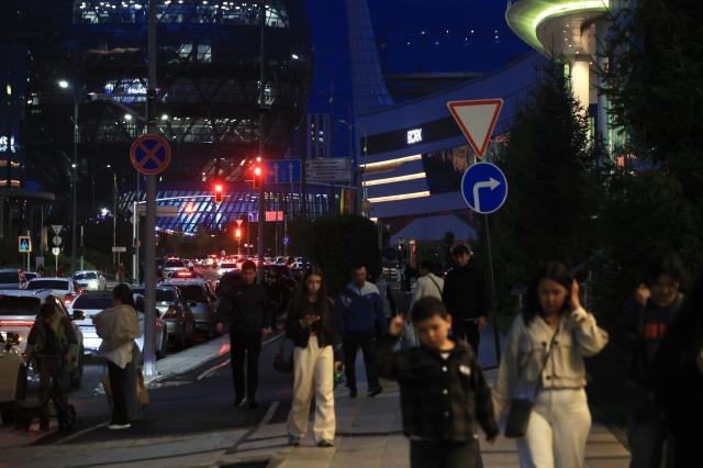 Pedestrians walk along a busy street in Astana Kazakhstan in the evening AJP Han Jun-gu