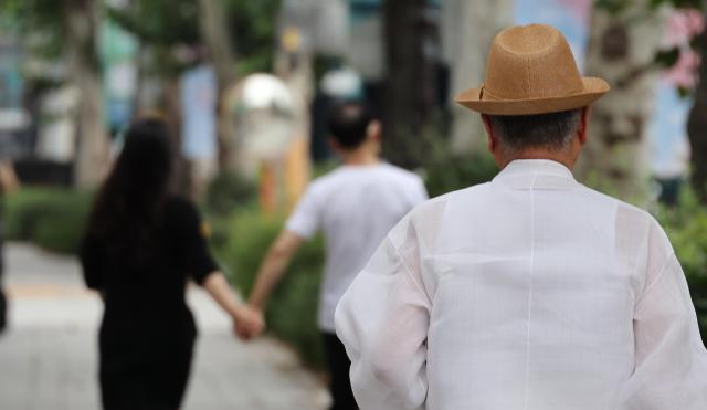 Pedestrians walk in Jongno District in central Seoul on July 29 2025 Yonhap