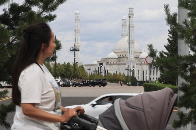 The Hazrat Sultan Mosque is seen in Astana Kazakhstan as a woman pushes a stroller nearby AJP Han Jun-gy