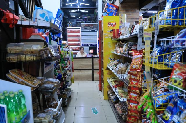 A clerk sits behind the counter at a neighborhood convenience store in Astana Kazakhstan AJP Han Jun-gu