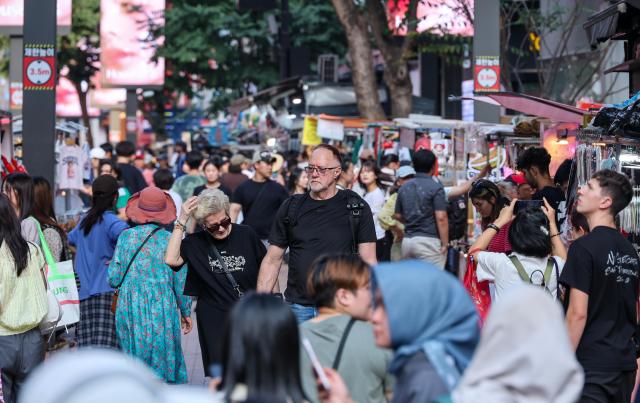 Foreign tourists walk along Myeongdong Street in Jung District Seoul on Aug 24 AJP Yoo Na-hyun
