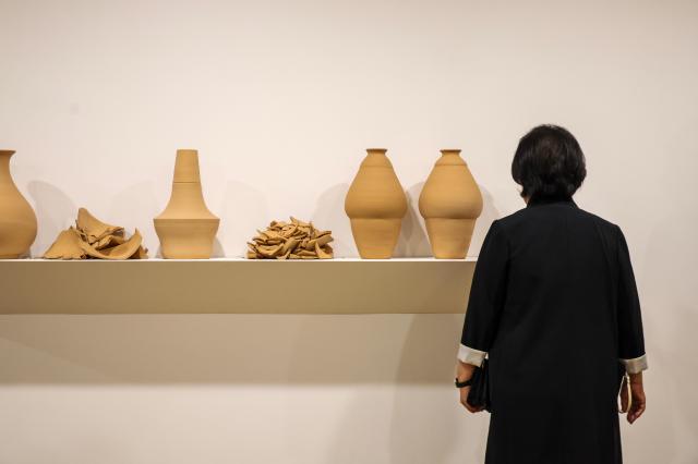 A visitor views an installation of intact and broken terracotta vessels at “Italy at Frieze: The Golden Trace” at the Italian ambassador’s residence in Seoul on Sept. 1, 2026. AJP Yoo Na-hyun
