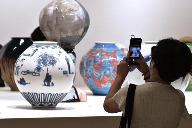 Visitors at KIAF Seoul are carefully looking into the artwork installed throughout COEX SEOUL on Sept. 03. AJP Joonha Yoo