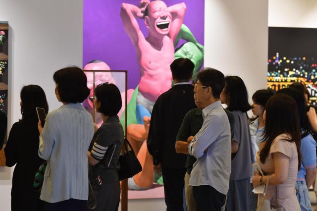 VIP visitors are looking through various artworks as they travel throughout COEX AJP Joonha Yoo