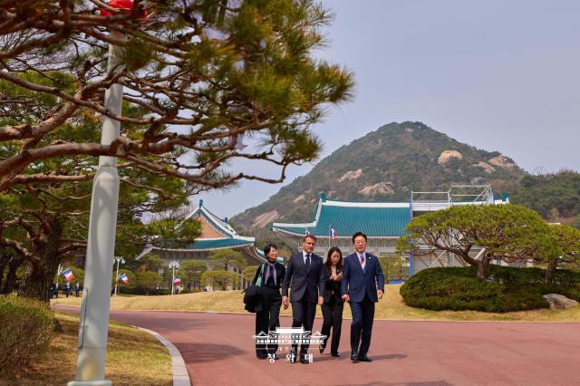 South Korean President Lee Jae Myung and French President Emmanuel Macron walk together at Cheong Wa Dae in Seoul during Macron’s state visit to South Korea on April 3 2026 Courtesy of Cheong Wa Dae