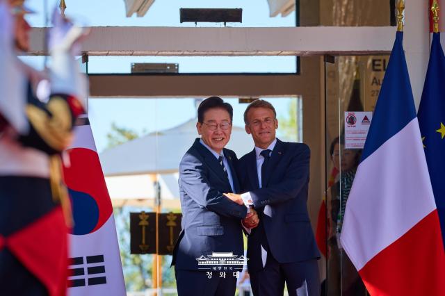 Presidents Lee Jae Myung of South Korea and Emmanuel Macron of France shake hands before they announce Global Film and Audiovisual Industry Investment Cooperation Initiative in France on Sept 7 2026 Cheong Wa Dae