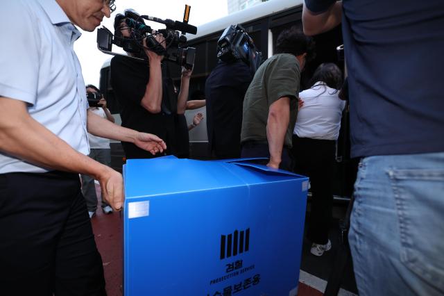 제주 실종 허위종결 사건을 수사하는 제주지검 관계자들이 8일 제주서부경찰서에 대한 압수수색을 마친 뒤 압수품을 차량에 싣고 있다 사진연합뉴스