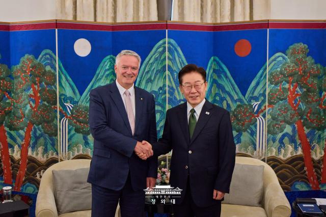 President Lee Jae Myung right shakes hands with OECD Secretary-General Mathias Cormann ahead of their meeting at a hotel in Paris on Sept 9 2026 during Lees state visit to France The meeting held to mark the 30th anniversary of South Koreas accession to the OECD focused on inclusive growth AI and digital transformation and future cooperation Courtesy of Cheong Wa Dae