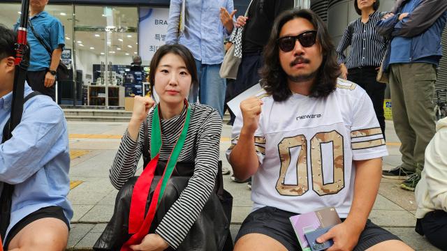 Song Hwa left and her husband Heo Woo-jin attend a rally opposing South Korea’s possible deployment to the Strait of Hormuz in Jongno Seoul Sept 12 2026 The couple said they joined the protest to show the government that public opposition to the deployment is widespread AJP Lee Jung-woo 