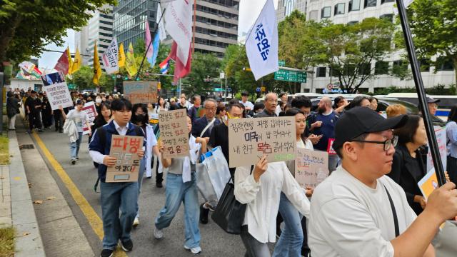Protesters march against South Korea’s possible deployment to the Strait of Hormuz in Jongno-gu Seoul Sept 12 2026 Placards read “Will America put food on our table for joining its war of aggression Don’t put my friend’s life on the menu” and “No justification no conscience no national interest — and no one to send” AJP Lee Jung-woo 