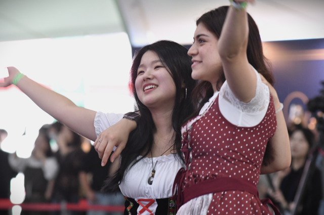 Two festivalgoers in Bavarian-style outfits dance inside the Big Tent during Oktoberfest Seoul 2026 at Oil Tank Culture Park in western Seoul on Sept 12 2026 AJP Joonha Yoo