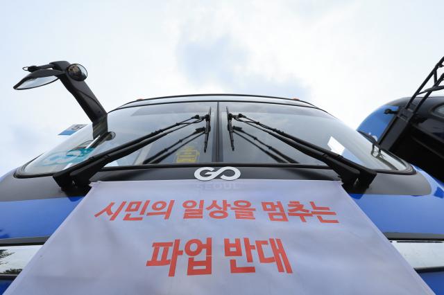 Buses display banners opposing strike