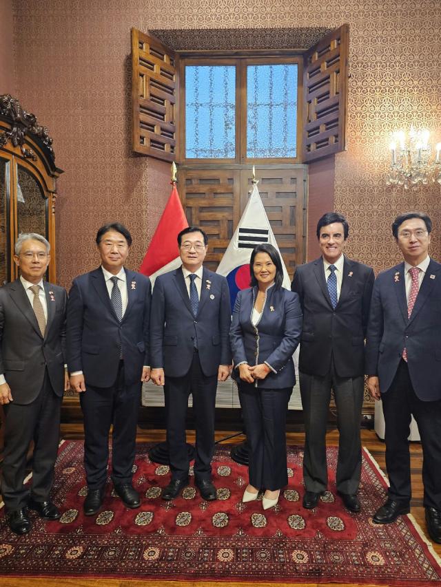 A South Korean presidential delegation sent to attend the inauguration of Peru’s President-elect Keiko Fujimori poses with Fujimori at Peru’s Foreign Ministry in Lima on July 27 2026 Rep Min Hong-chul who led the delegation as President Lee Jae Myung’s special envoy stands third from left while Fujimori stands fourth from left Courtesy of Ministry of Foreign Affairs 