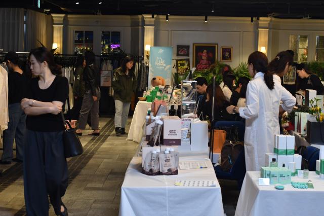 Visitors browse booths at the RISE UP Vol1 charity bazaar at MEMEMI GARDEN in southern Seoul on Sept 17 2026 AJP Joonha Yoo