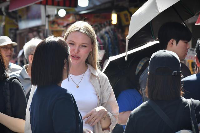 A foreign tourist shops for accessories at a stall inside Namdaemun Market in central Seoul Sept 22 2026 AJP Joonha Yoo