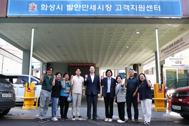 정명근 화성특례시장이 22일 발안만세시장 고객지원센터 앞에서 상인들과 함께 기념촬영을 하고 있다 사진화성시