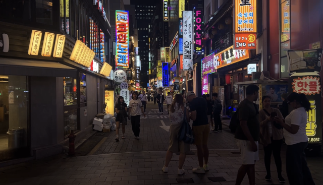 Pedestrians walk through a brightly lit street near Jongno in central Seoul on Sept 22 2026 AJP Kim Hee-su