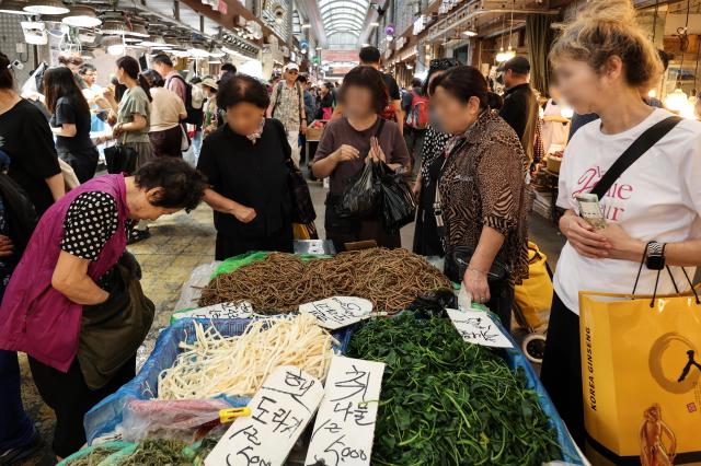 Shoppers select namul cooked vegetables for Chuseok meal at a marketplace in northern Seoul on Sept 23 2026 AJP Han Jun-gu 