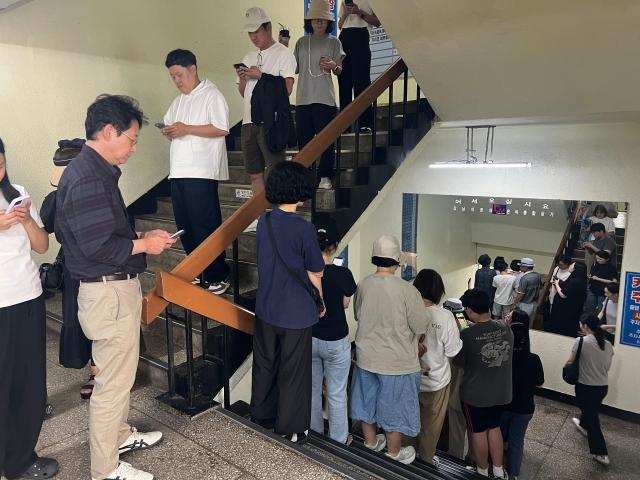 People are lined up against the stairwell of Eunma market in order to get a plate of Jeon from a very well known parlor on Sept 25 AJP Joonha Yoo