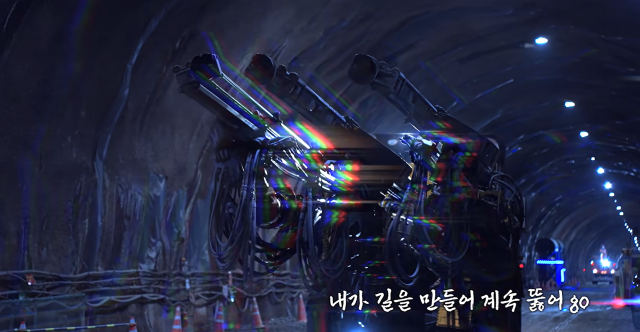 Captured photo of a music video of Break Through from a YouTube channel cun_ssul_cafe show members of construction workers are performing in a hip hop music video