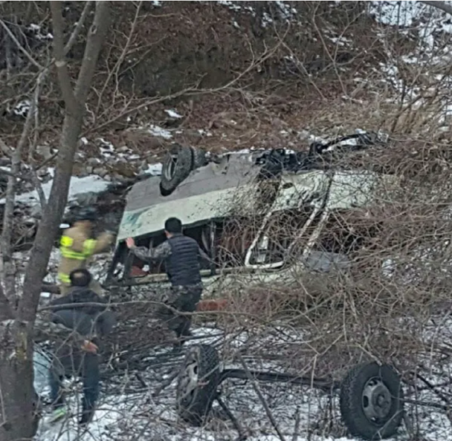 A 25-seat military bus carrying new recruits lies overturned after crashing through a guardrail and rolling about 20 meters down a ravine near Dogo Tunnel in Bangsan-myeon Yanggu County Gangwon Province on Jan 2 2018 Courtesy of Yanggu County