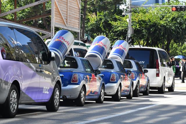 Red Bull-branded Mini cars topped with giant energy drink cans are parked along a street near the venue of a Red Bull event in central Seoul on Oct 1 2026 AJP Joonha Yoo