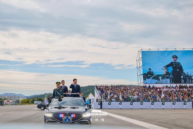 South Korean President Lee Jae Myung salutes while reviewing troops aboard an open-top vehicle during a ceremony marking the 78th Armed Forces Day at the Gyeryongdae military headquarters in Gyeryong South Chungcheong Province on Oct 1 2026 The ceremony featured a military review and demonstrations of South Korea’s advanced defense capabilities Courtesy of Cheong Wa Dae