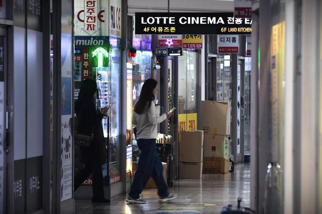 Visitors walk past electronics shops in an arcade at the Yongsan Electronics Market in Seoul. AJP Joonha Yoo