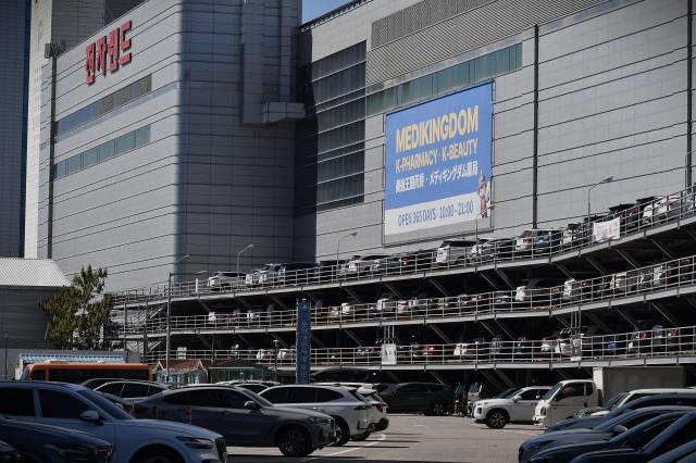 A banner for Medikingdom, a K-pharmacy and K-beauty store, hangs on the exterior of the Electronics Land building at the Yongsan Electronics Market in Seoul. AJP Joonha Yoo