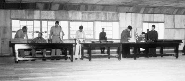 UN delegate Lieut Gen William K Harrison Jr seated left and Korean Peoples Army and Chinese Peoples Volunteers delegate Gen Nam Il seated right signing the Korean War armistice agreement at Panmunjŏm Korea July 27 1953