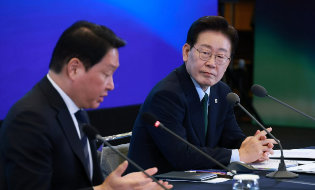 이재명 대통령이 7일 서울 한 회의장에서 진행된 한국형 녹색대전환K-GX 전략 국민보고회에서 최태원 대한상의 회장의 발언을 듣고 있다 사진연합뉴스