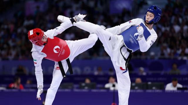 South Korea’s Kim Yu-jin right competes against Iran’s Nahid Kiani in the women’s 57-kilogram taekwondo final at the Paris Olympics at the Grand Palais in Paris on Aug 8 2024 Courtesy of Olympicscom 