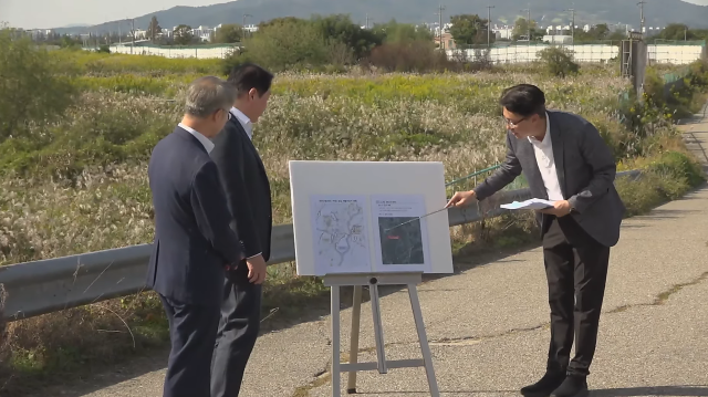 SK Group Chairman Chey Tae-won third from right and Jeonnam-Gwangju Integrated Special City Mayor Min Hyung-bae listen to a briefing on the suitability of the Gwangju Military Airport site on October 9 2026 Screenshot from Jeonnam-Gwangju TV