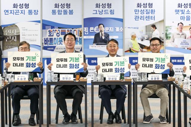 정명근 화성특례시장이 참석자들과 모두의 기본 더나은 화성 문구가 담긴 펫말을 들고 기념촬영을 하고 있다 사진화성시