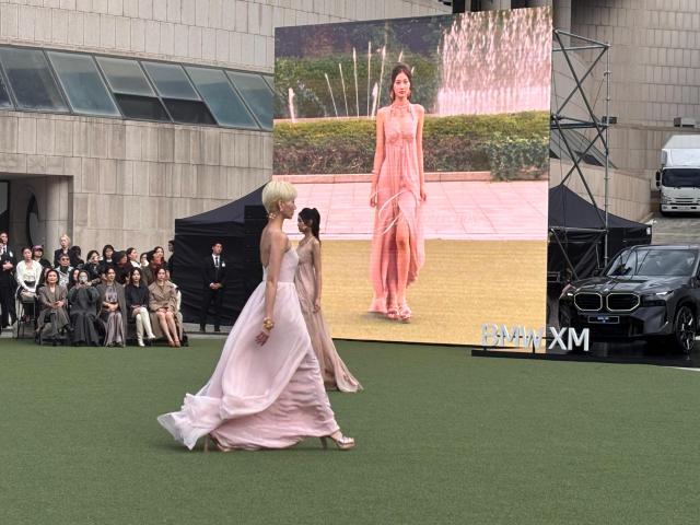 A model in a flowing pale pink gown walks the runway during Miss Gee Collections 2027 springsummer fashion show at the Seoul Arts Center in southern Seoul on Oct 15 2026 AJP Ryu Yuna