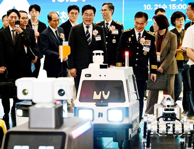 박찬대 인천광역시장이 21일 송도컨벤시아에서 열린 2026 국제치안산업대전에서 치안로봇과 행사장으로 입장하고 있다 사진인천시