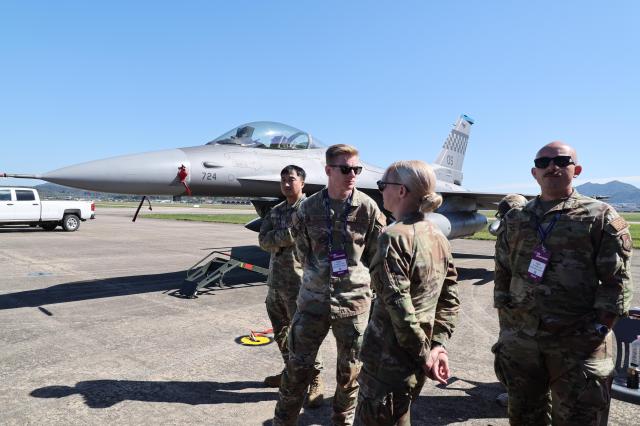 US service members stand beside an F-16 fighter jet at the Sacheon Airshow in Sacheon South Gyeongsang Province AJP Yoo Na-hyun