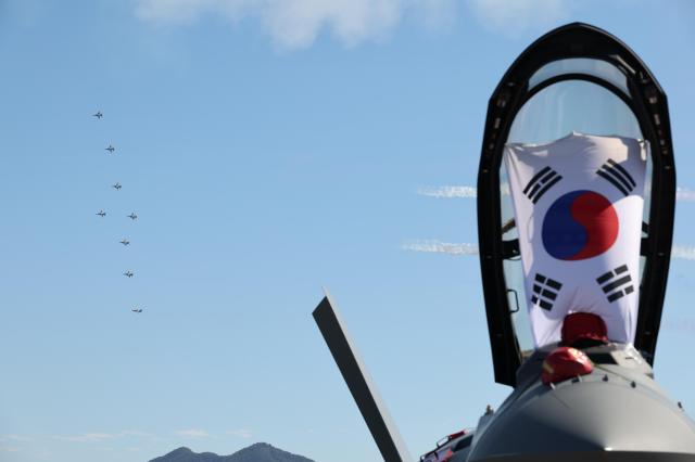 The South Korean flag hangs inside an open cockpit canopy as the Black Eagles aerobatic team flies overhead at the Sacheon Airshow in South Gyeongsang Province AJP Yoo Na-hyun