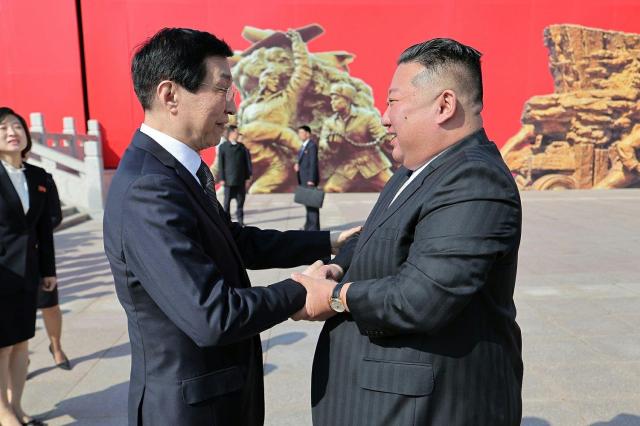 North Korean leader Kim Jong-un right greets Wang Huning chairman of the National Committee of the Chinese Peoples Political Consultative Conference Courtesy of Rodong Sinmun 
