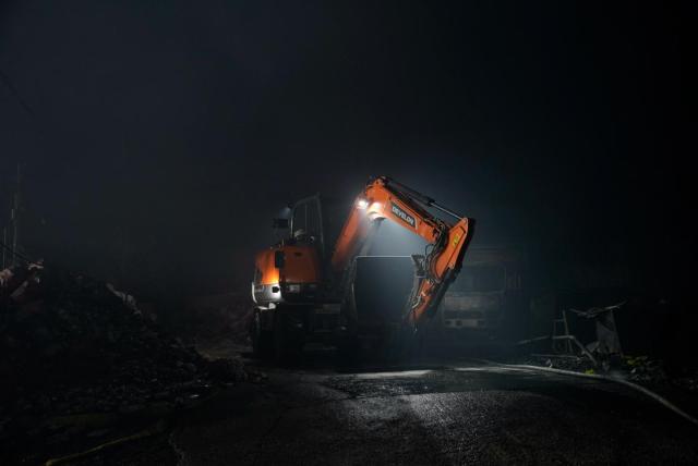 Excavator pushing through the remaining of Guryong Village Courtesy of CHOI Yohan