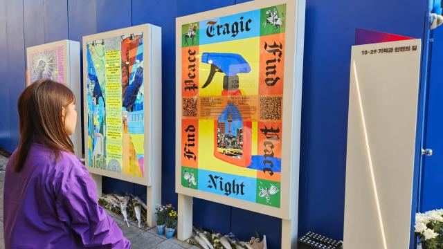 Yu Jung whose younger sister Yu Yeon-ju died in the 2022 Itaewon crowd crush looks at memorial artwork displayed along the Path of Memory and Safety in Itaewon Seoul on October 28 2026 a day before the disasters fourth anniversary AJP Lee Jung-woo