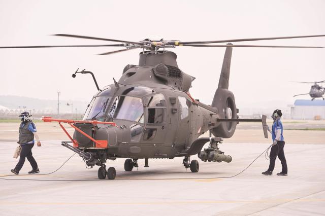 Korea Aerospace Industries KAI LAH Miron light armed helicopter flies over a mountainous landscape in South Korea Courtesy of KAI